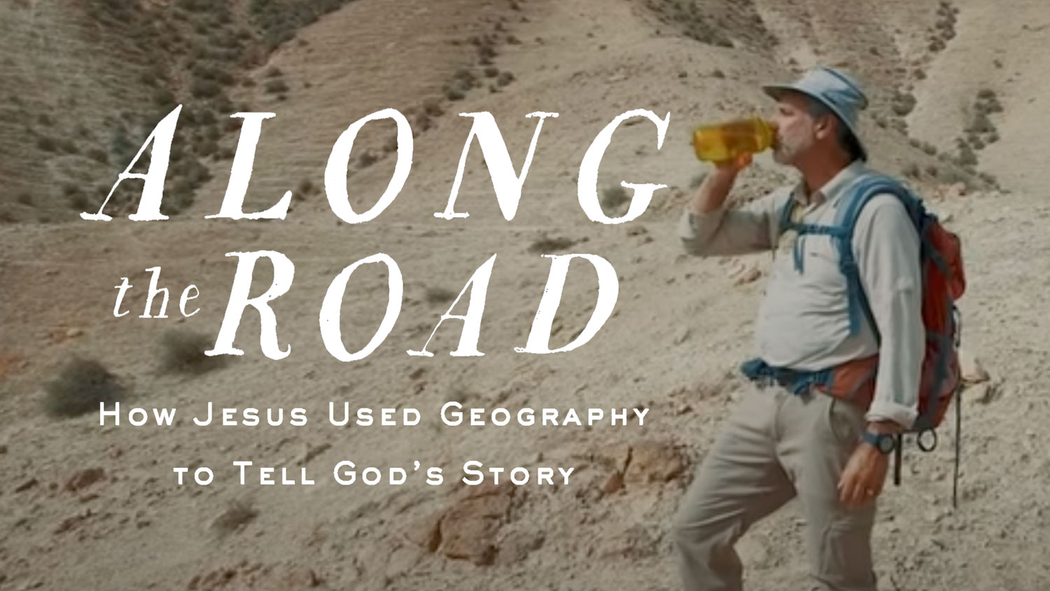 Man drinking in desert, 'Along the Road' text overlay.