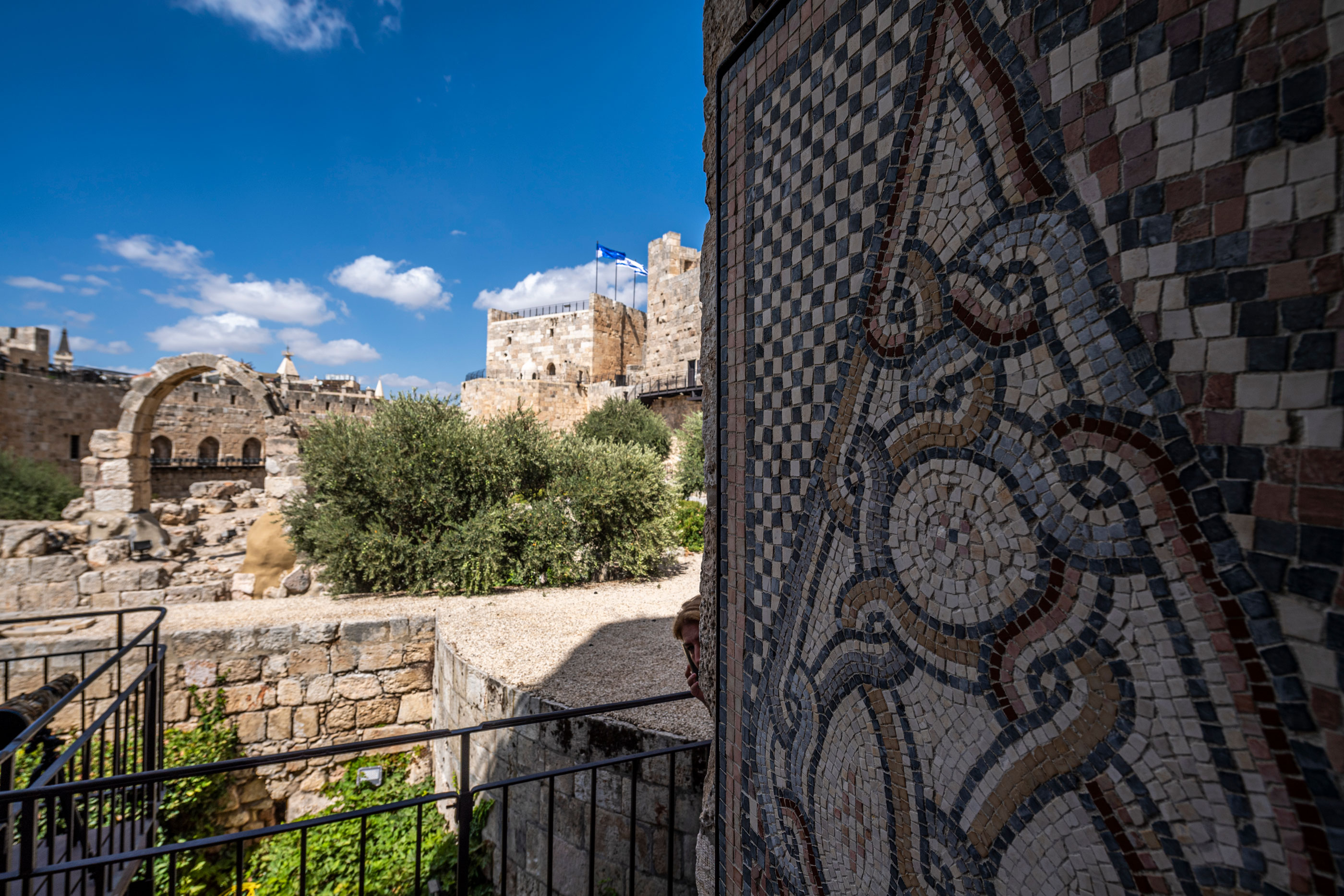 Ancient stone wall and decorative mosaic in Jerusalem.