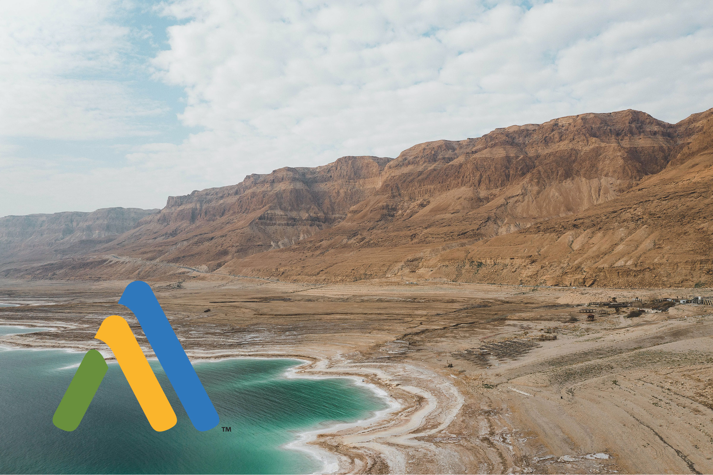 Desert mountains, coastline with logo in foreground