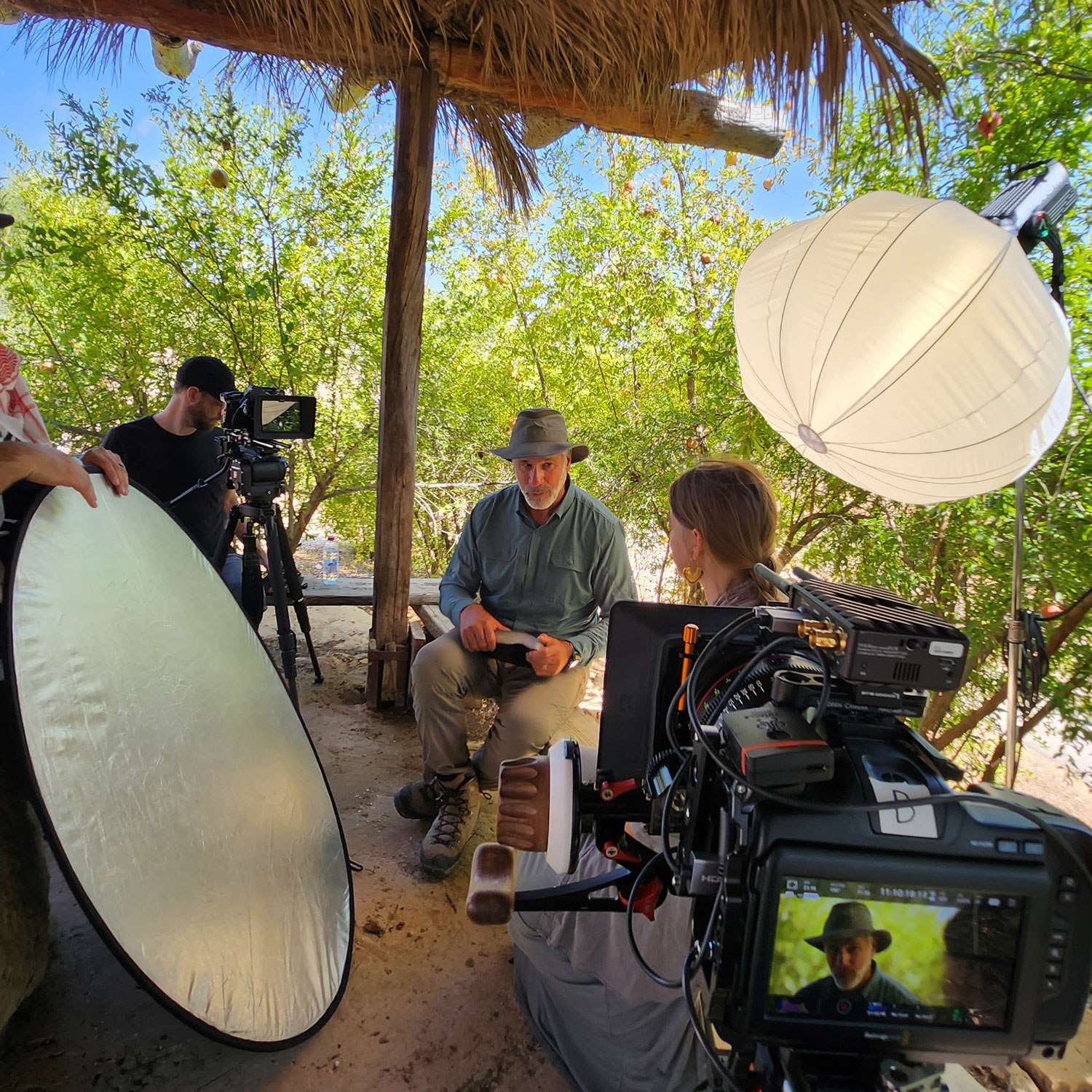 Filmmaking team setting up outdoor interview.